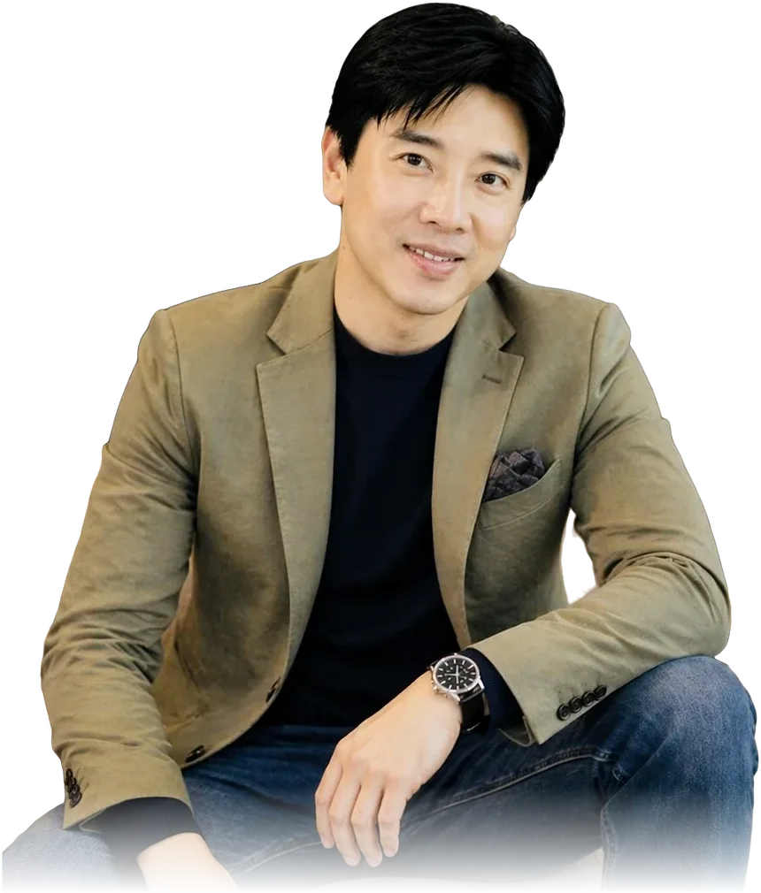 Dato' Seri Ivan Teh in an olive blazer and jeans, seated and smiling